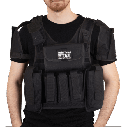 A man wearing a vest with many pockets. A man wearing a vest with many pockets.